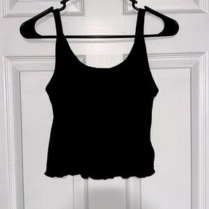 A black tank that is a little shorter on the back side